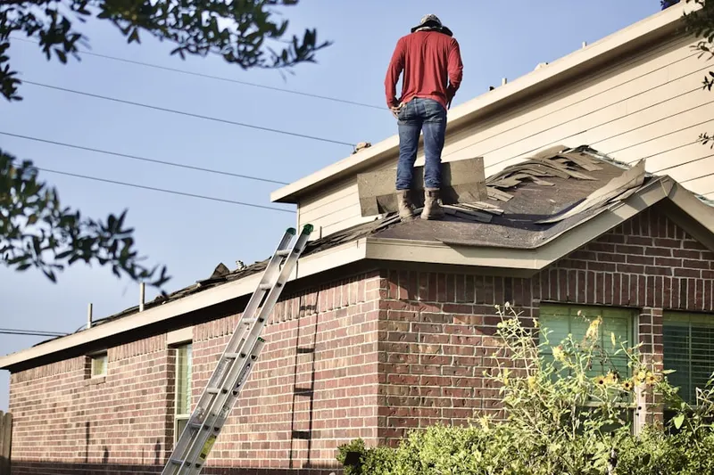 Professional roofer working on a residential roof in Canutillo